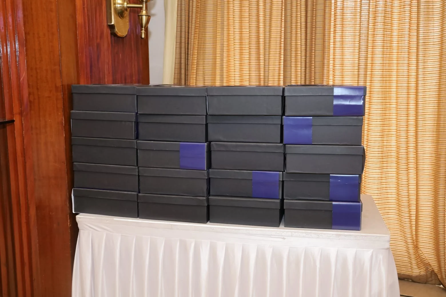 Stacked black ima26 conference gift boxes at the Mumbai venue