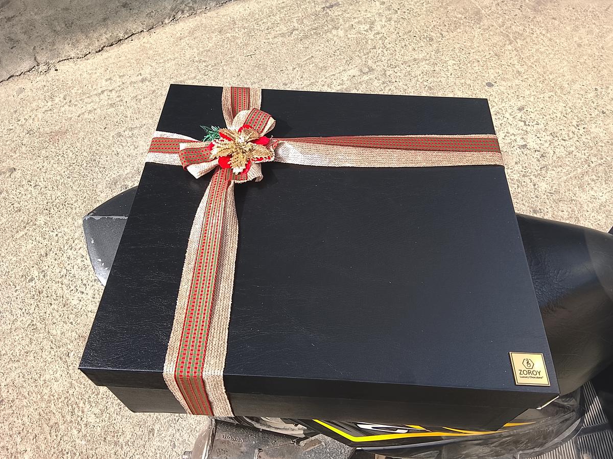 Black gift box tied with a festive ribbon and bow